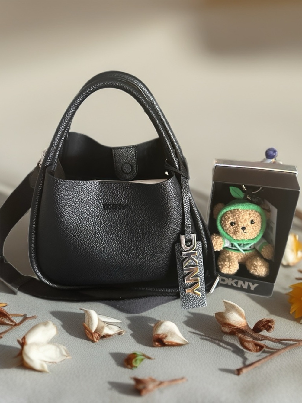 DKNY BLACK PEBBLED LEATHER SHOULDER BAG WITH DKNY TEDDY BEAR CHARM NOT INCLUDED.